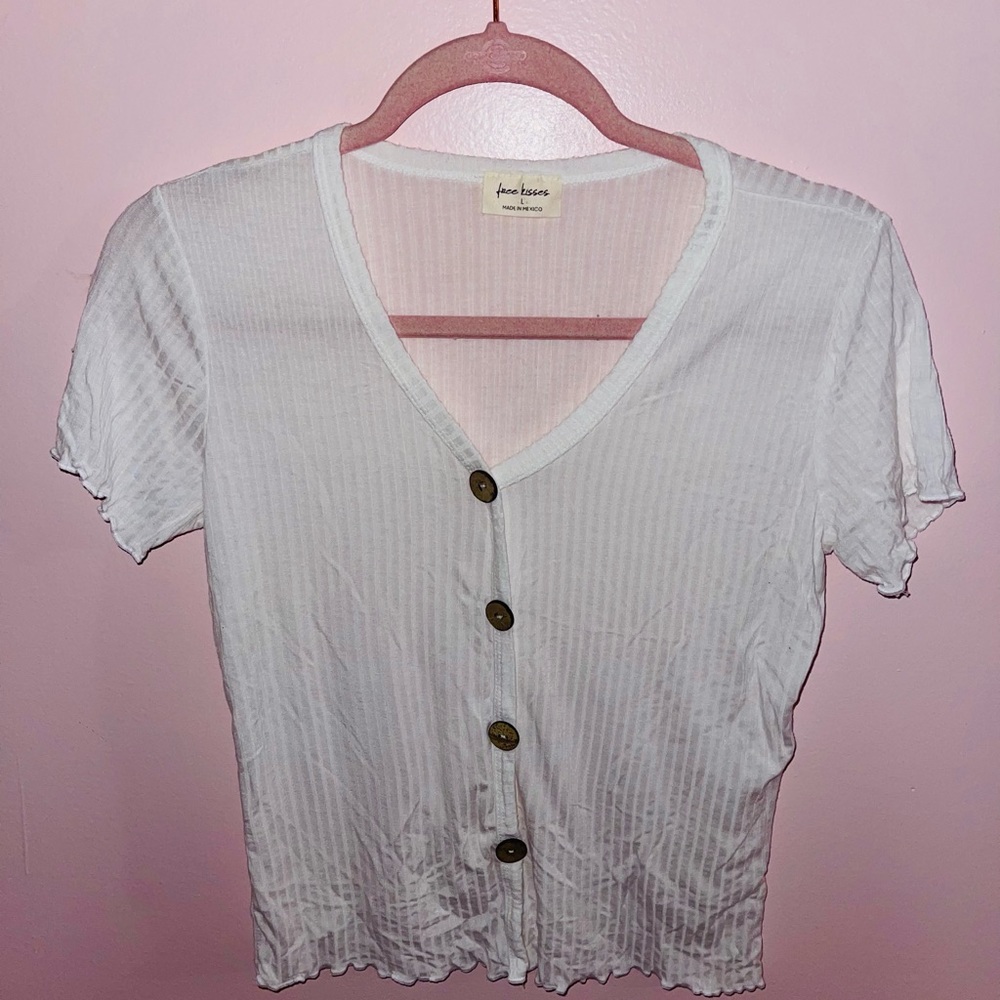 White tshirt with wooden bottoms on front